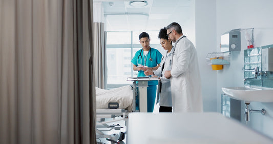 Hospital staff reviewing patient charts in a bright, modern room. Aromatherapy patient care.